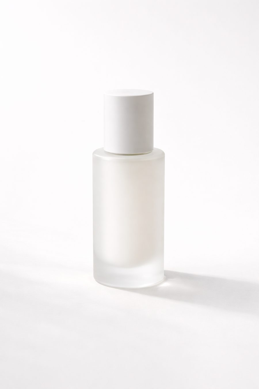 A minimalist frosted glass cosmetic bottle silhouette on a white background.